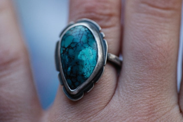 Close-up of a natural turquoise ring set in silver jewelry